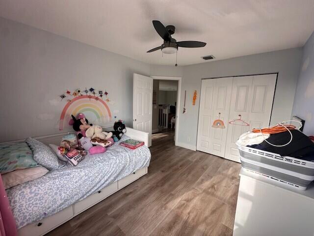 9202 Olmstead Dr, Lake Worth, FL 33467 - bedroom with wood finished floors, a closet, a ceiling fan, and baseboards