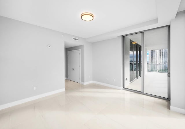 3100 N Ocean Dr Unit H-1708, Singer Island, FL 33404 - empty room with baseboards, expansive windows, and light tile patterned floors