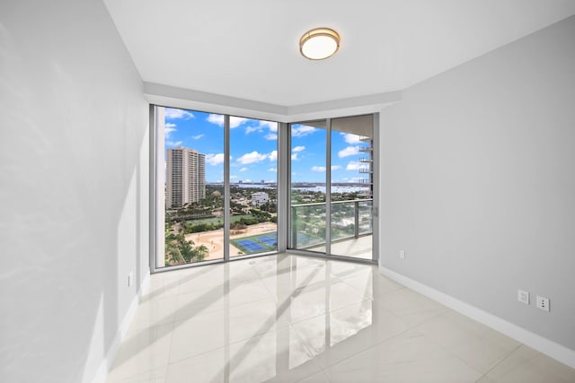 3100 N Ocean Dr Unit H-1708, Singer Island, FL 33404 - unfurnished room featuring baseboards, a wall of windows, and a view of city