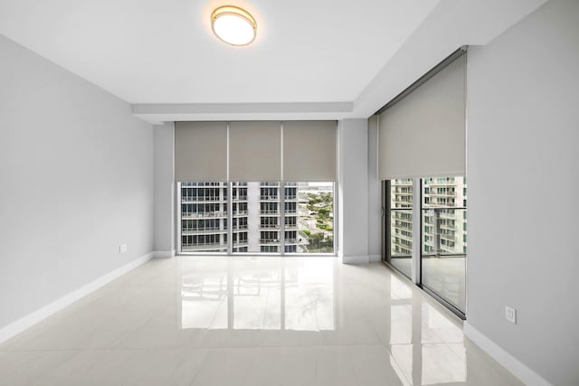 3100 N Ocean Dr Unit H-1708, Singer Island, FL 33404 - spare room with light tile patterned floors and baseboards