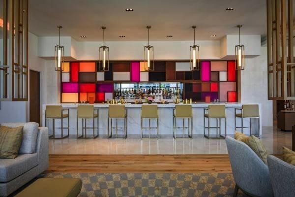 3100 N Ocean Dr Unit H-1708, Singer Island, FL 33404 - bar area featuring wood finished floors and decorative light fixtures