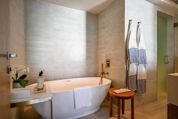 3100 N Ocean Dr Unit H-1708, Singer Island, FL 33404 - full bath with a soaking tub, tile walls, and a shower with shower door