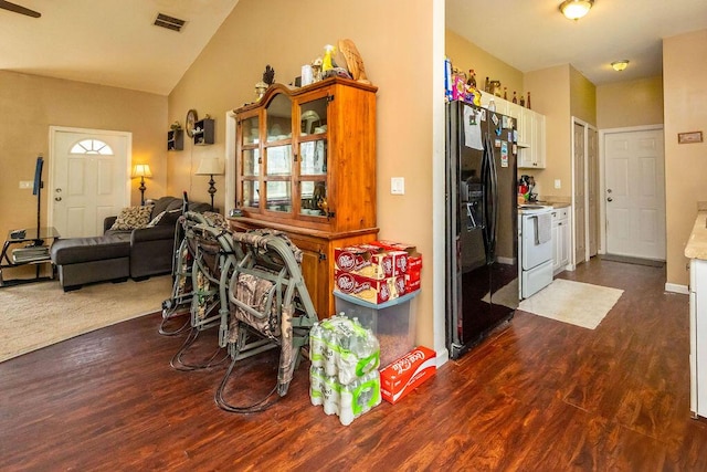 17331 38th Rd N, Loxahatchee, FL 33470 - kitchen with black refrigerator with ice dispenser, white electric range, dark wood-style flooring, white cabinetry, and high vaulted ceiling