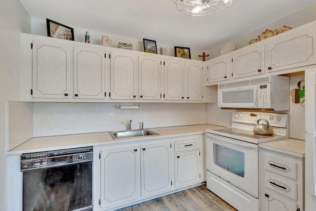 212 Somerset K, West Palm Beach, FL 33417 - kitchen featuring white appliances, a sink, light countertops, and light wood finished floors