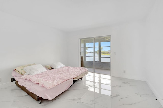20 Somerset Unit A, West Palm Beach, FL 33417 - bedroom with marble finish flooring, a water view, baseboards, and access to exterior