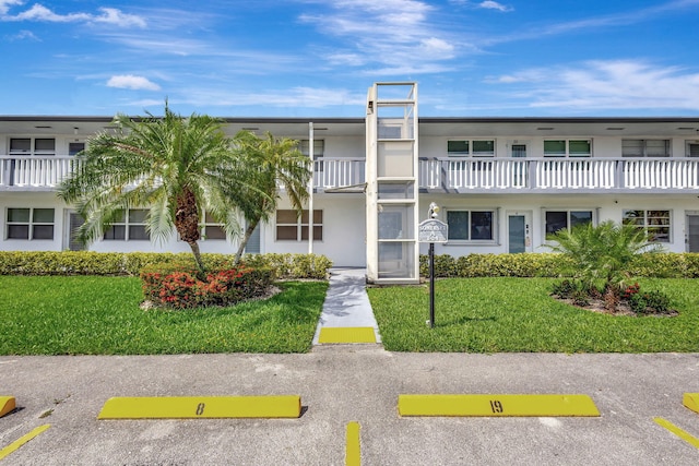 20 Somerset Unit A, West Palm Beach, FL 33417 - view of property featuring uncovered parking