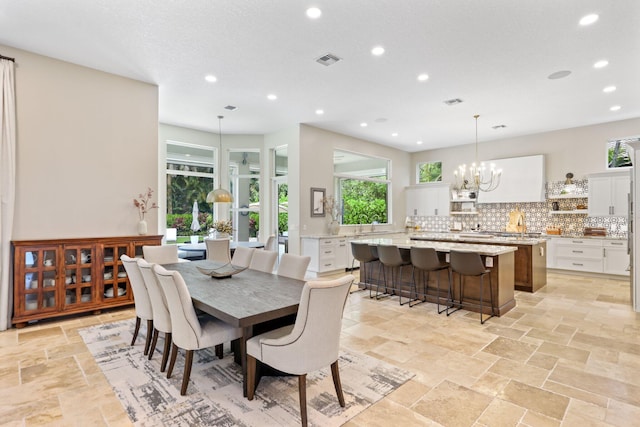 7815 Fairway Ln, West Palm Beach, FL 33412 - dining area featuring a chandelier, recessed lighting, and stone tile flooring