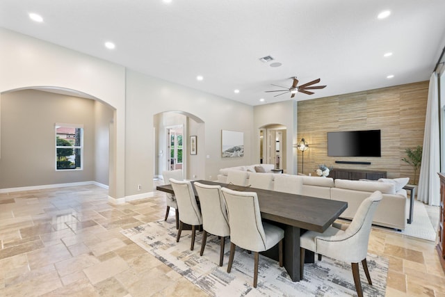 7815 Fairway Ln, West Palm Beach, FL 33412 - dining space featuring arched walkways, stone tile flooring, ceiling fan, recessed lighting, and baseboards