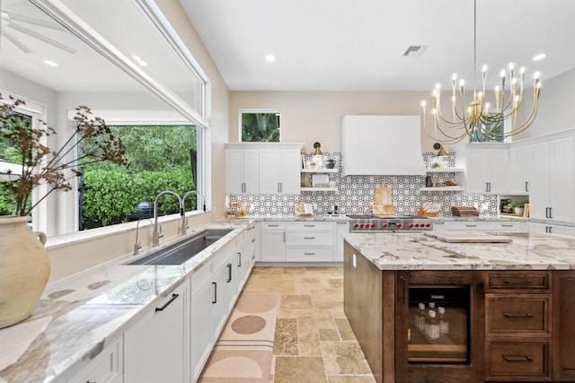 7815 Fairway Ln, West Palm Beach, FL 33412 - kitchen featuring a sink, extractor fan, open shelves, light stone finish floors, and decorative backsplash