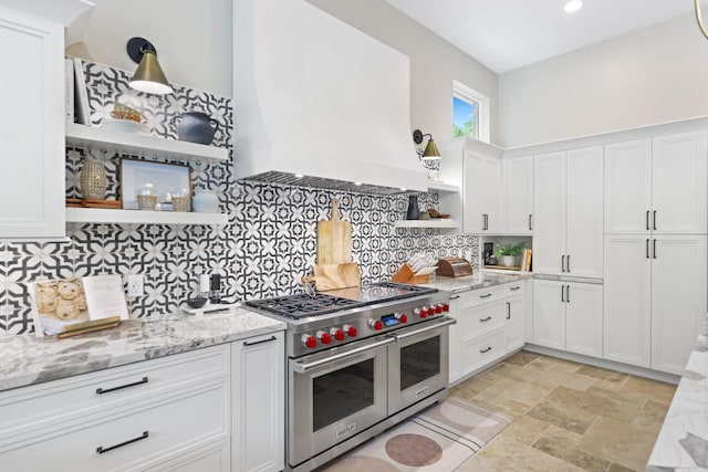 7815 Fairway Ln, West Palm Beach, FL 33412 - kitchen with open shelves, double oven range, custom range hood, white cabinets, and light stone counters