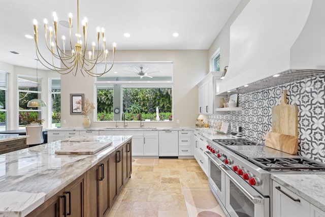 7815 Fairway Ln, West Palm Beach, FL 33412 - kitchen featuring double oven range, custom range hood, a sink, recessed lighting, and plenty of natural light