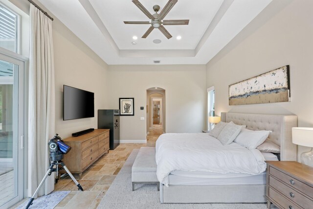 7815 Fairway Ln, West Palm Beach, FL 33412 - bedroom featuring stone tile floors, arched walkways, multiple windows, access to outside, and recessed lighting