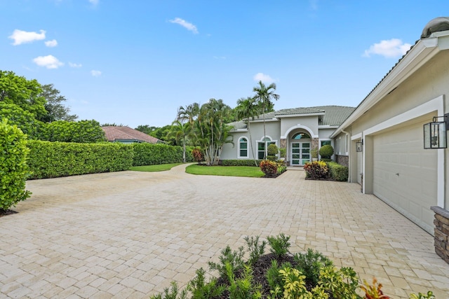 7815 Fairway Ln, West Palm Beach, FL 33412 - view of patio featuring decorative driveway and a garage