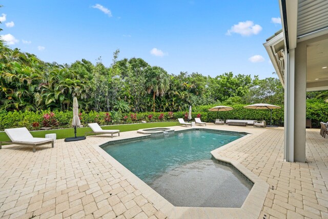 7815 Fairway Ln, West Palm Beach, FL 33412 - view of swimming pool with a patio area and a pool with connected hot tub
