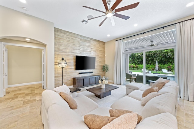 7815 Fairway Ln, West Palm Beach, FL 33412 - living area with ceiling fan, stone tile flooring, baseboards, recessed lighting, and an accent wall