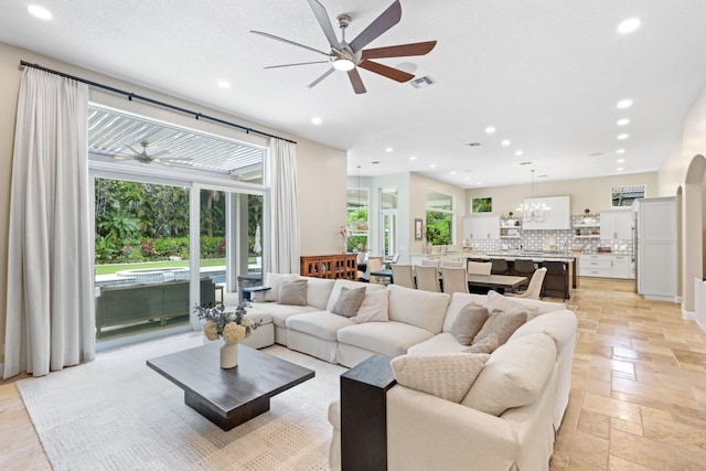 7815 Fairway Ln, West Palm Beach, FL 33412 - living area featuring ceiling fan, recessed lighting, stone tile floors, and a chandelier