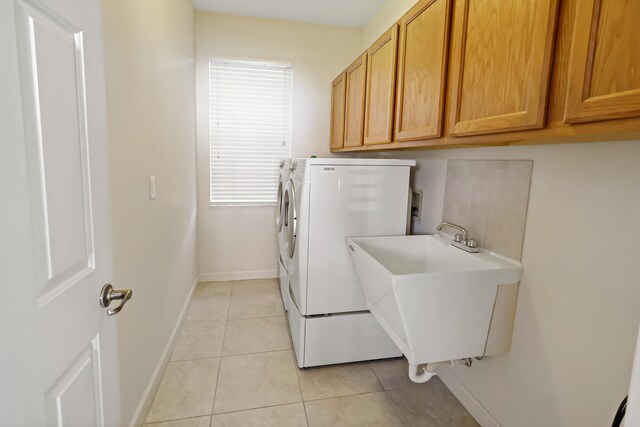2365 55th Sq, Vero Beach, FL 32966 - laundry room featuring baseboards, light tile patterned floors, cabinet space, and washer hookup