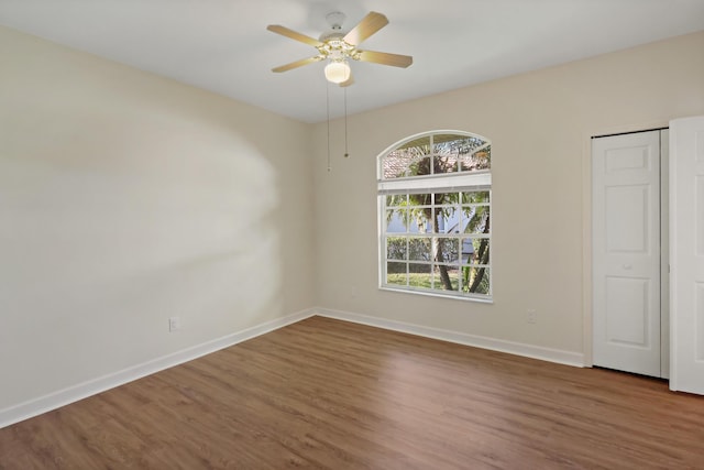 2365 55th Sq, Vero Beach, FL 32966 - empty room featuring baseboards, wood finished floors, and ceiling fan