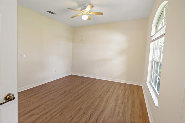 2365 55th Sq, Vero Beach, FL 32966 - unfurnished room with wood finished floors, baseboards, and a ceiling fan