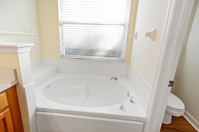 2365 55th Sq, Vero Beach, FL 32966 - full bathroom featuring a garden tub, toilet, and vanity