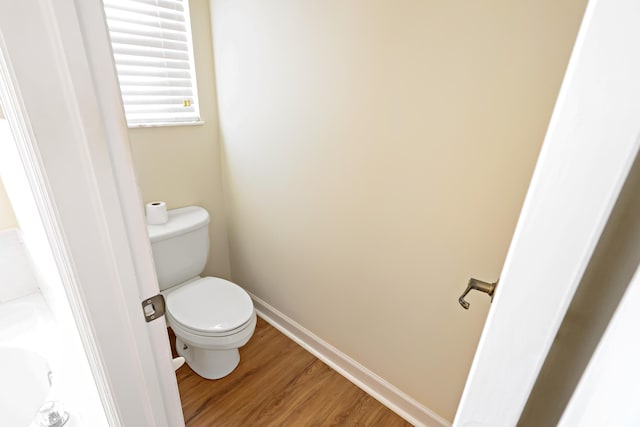 2365 55th Sq, Vero Beach, FL 32966 - bathroom featuring wood finished floors, toilet, and baseboards