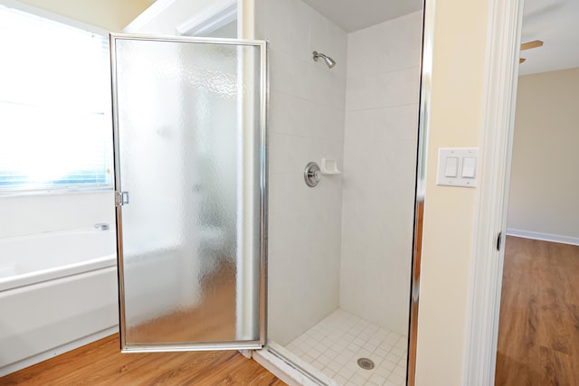 2365 55th Sq, Vero Beach, FL 32966 - bathroom featuring a stall shower, a garden tub, and wood finished floors