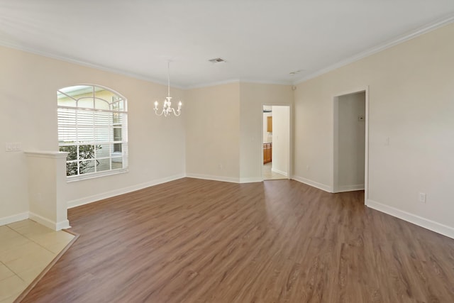 2365 55th Sq, Vero Beach, FL 32966 - empty room with a chandelier, wood finished floors, baseboards, and ornamental molding