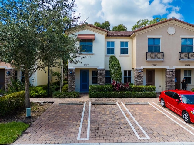8328 Cocoplum Sound Ln, West Palm Beach, FL 33411 - multi unit property with stucco siding, stone siding, uncovered parking, and a tiled roof