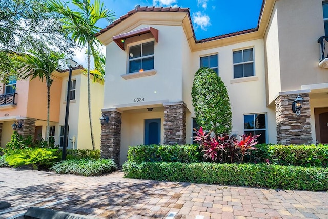 8328 Cocoplum Sound Ln, West Palm Beach, FL 33411 - view of front facade with stone siding, stucco siding, and a tiled roof