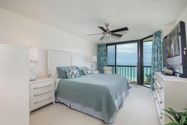 8800 S Ocean Dr Unit 710, Jensen Beach, FL 34957 - bedroom featuring access to outside, floor to ceiling windows, light colored carpet, and ceiling fan