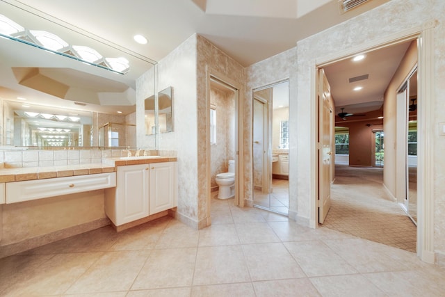 7535 Tarpon Cove Cir, Lake Worth, FL 33467 - bathroom featuring toilet, vanity, tile patterned floors, baseboards, and a ceiling fan