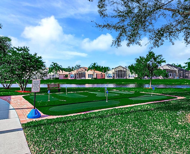 7535 Tarpon Cove Cir, Lake Worth, FL 33467 - view of property's community with an area to practice putting, a residential view, and a yard