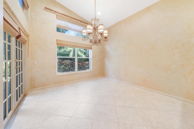 7535 Tarpon Cove Cir, Lake Worth, FL 33467 - tiled empty room with a chandelier, baseboards, and high vaulted ceiling