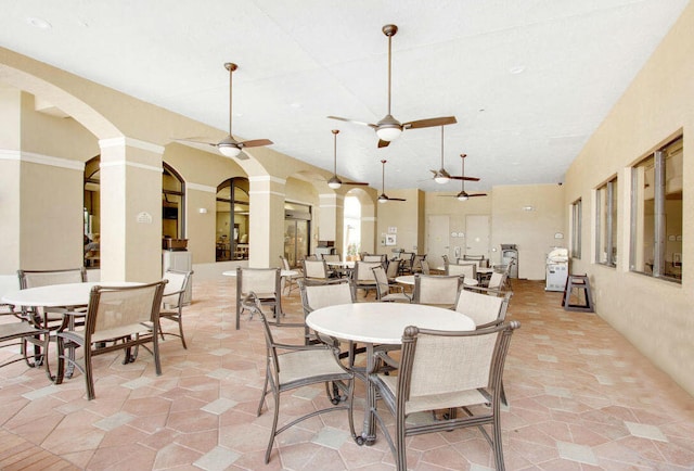 7535 Tarpon Cove Cir, Lake Worth, FL 33467 - dining room featuring arched walkways, a ceiling fan, and decorative columns