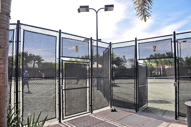 7535 Tarpon Cove Cir, Lake Worth, FL 33467 - view of tennis court featuring a gate