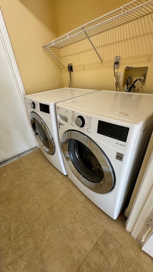 22544 Sawfish Ter, Boca Raton, FL 33428 - washroom with washing machine and clothes dryer and tile patterned floors