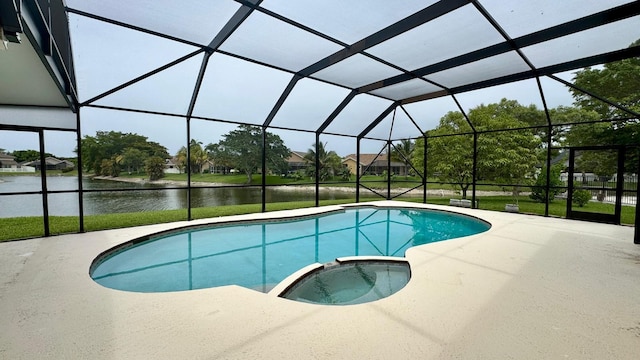 22544 Sawfish Ter, Boca Raton, FL 33428 - view of pool featuring a pool with connected hot tub, a patio area, a water view, and glass enclosure