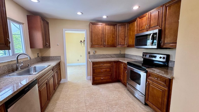 22544 Sawfish Ter, Boca Raton, FL 33428 - kitchen featuring appliances with stainless steel finishes, a sink, recessed lighting, baseboards, and brown cabinets