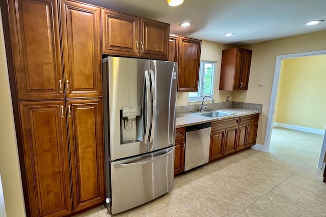 22544 Sawfish Ter, Boca Raton, FL 33428 - kitchen featuring stainless steel appliances, a sink, light countertops, light tile patterned floors, and baseboards