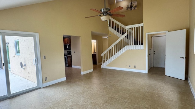 22544 Sawfish Ter, Boca Raton, FL 33428 - unfurnished living room with a ceiling fan, high vaulted ceiling, stairway, baseboards, and a chandelier