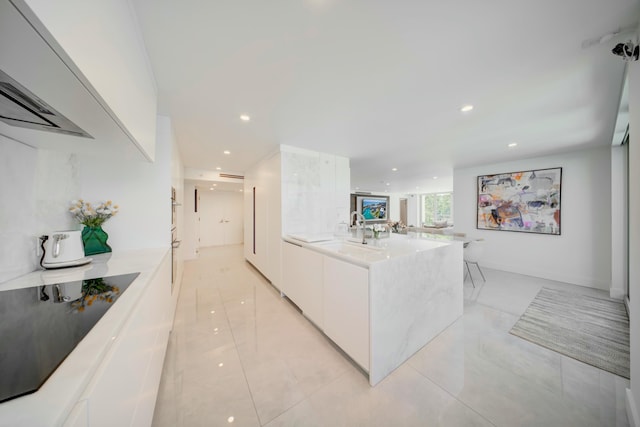 901 E Camino Real Unit 2A, Boca Raton, FL 33432 - kitchen with modern cabinets, white cabinetry, a peninsula, light countertops, and recessed lighting