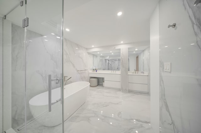 901 E Camino Real Unit 2A, Boca Raton, FL 33432 - bathroom with vanity, recessed lighting, a soaking tub, marble tiled flooring, and a marble finish shower