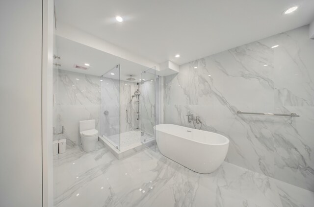 901 E Camino Real Unit 2A, Boca Raton, FL 33432 - bathroom with marble tiled flooring, a marble finish shower, a soaking tub, toilet, and recessed lighting