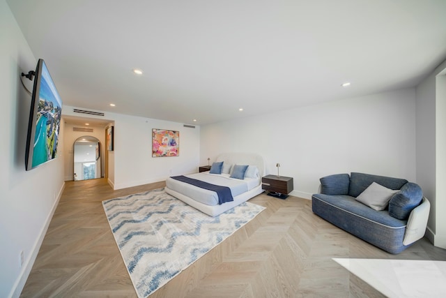 901 E Camino Real Unit 2A, Boca Raton, FL 33432 - bedroom featuring baseboards, arched walkways, and recessed lighting