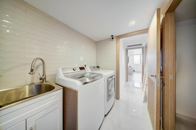 901 E Camino Real Unit 2A, Boca Raton, FL 33432 - washroom featuring separate washer and dryer, tile walls, and light tile patterned flooring
