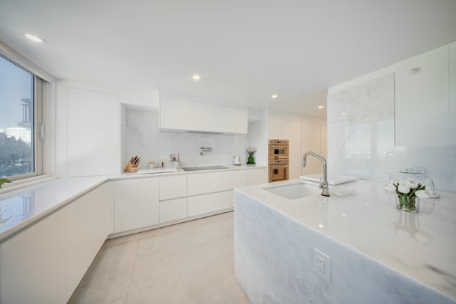 901 E Camino Real Unit 2A, Boca Raton, FL 33432 - kitchen featuring modern cabinets, a sink, white cabinetry, light countertops, and recessed lighting