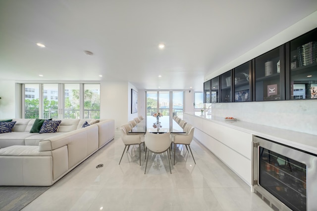 901 E Camino Real Unit 2A, Boca Raton, FL 33432 - dining space featuring beverage cooler, plenty of natural light, recessed lighting, and light tile patterned floors