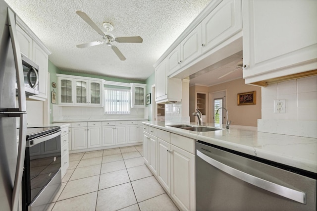1803 SW 5th Ave, Boynton Beach, FL 33426 - kitchen with stainless steel appliances, a ceiling fan, a sink, glass insert cabinets, and healthy amount of natural light
