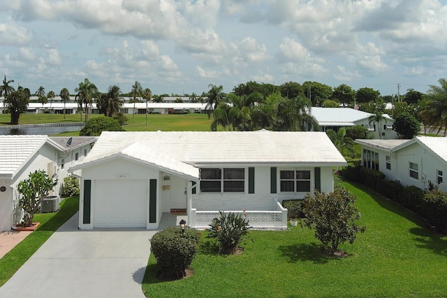 1803 SW 5th Ave, Boynton Beach, FL 33426 - view of front of home featuring concrete driveway, a garage, a front yard, cooling unit, and stucco siding