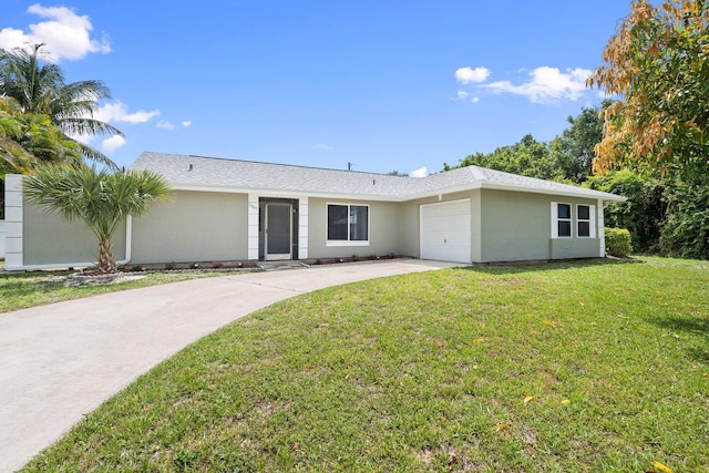 2307 SE Seafury Ln SE, Port Saint Lucie, FL 34952 - ranch-style house with a garage, driveway, a front yard, and stucco siding